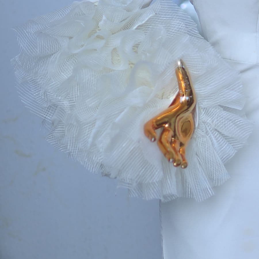 Close-up of layered ivory tulle ruffles on a sleeve.
