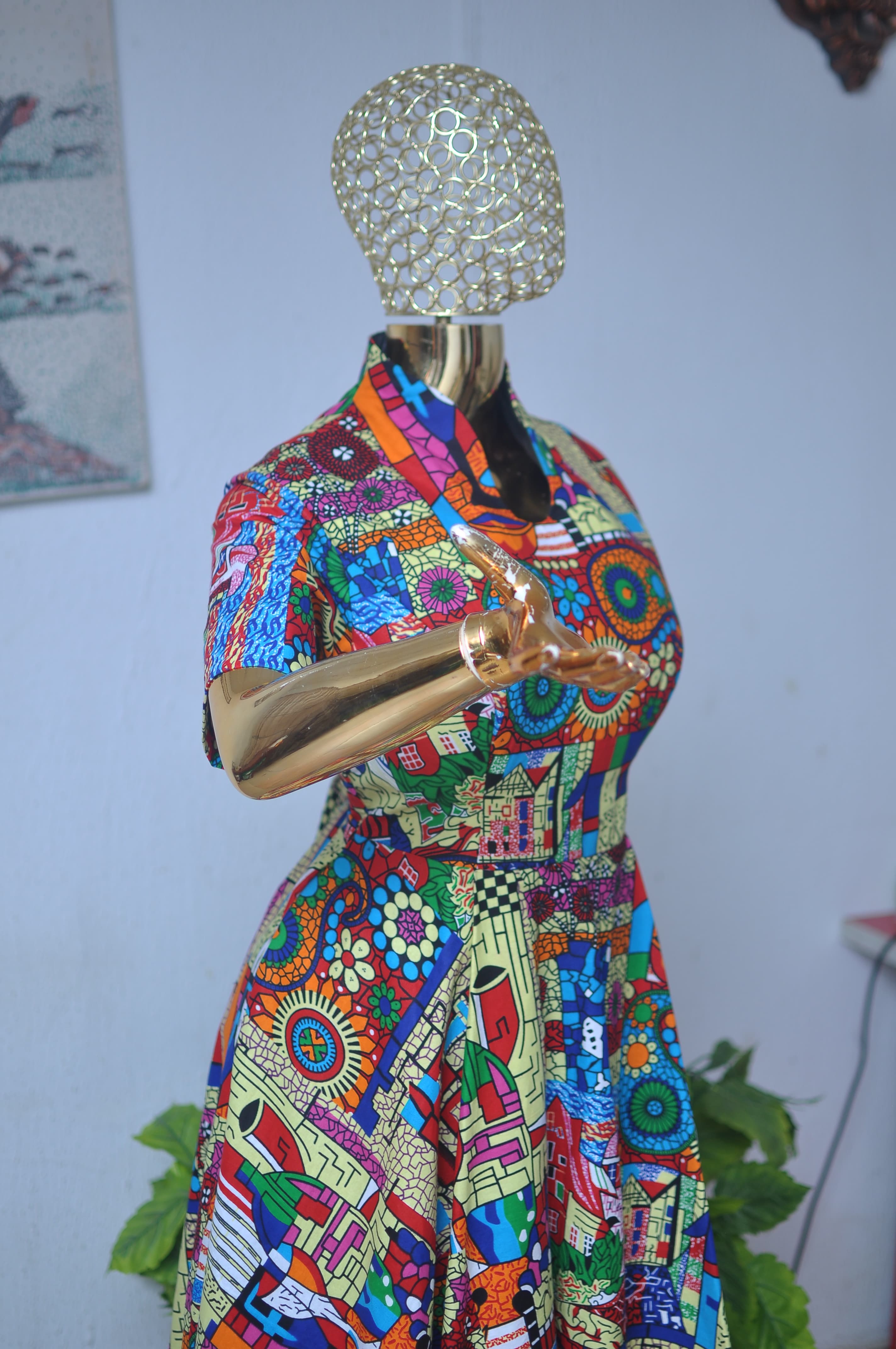 Abstract mosaic-print kaftan in red, blue, green and gold.